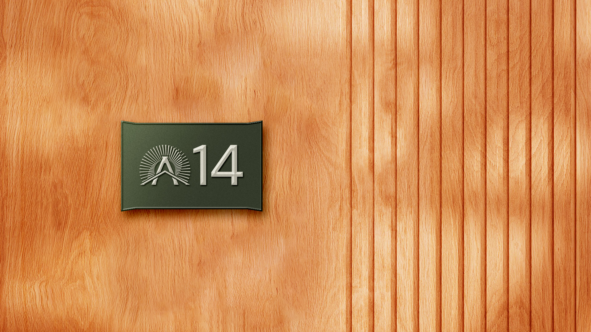 Olive door plaque reading A14 with the Alora sunburst mark, on wood panelling