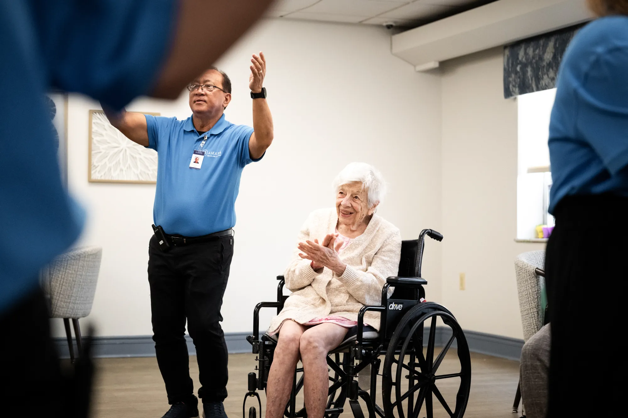An Amara staff member and a resident laughing mid-game in the activity room