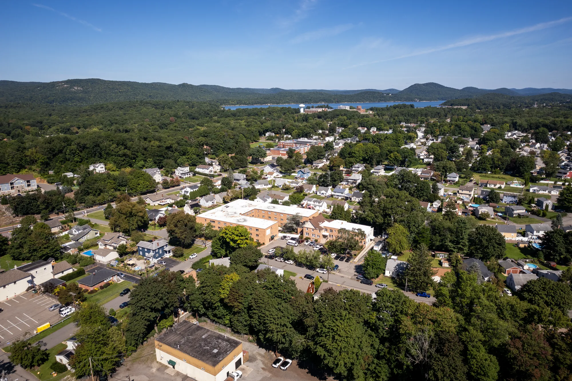 Aerial view over Haskell, New Jersey, with the Amara building below and the Ramapo hills and reservoir on the horizon