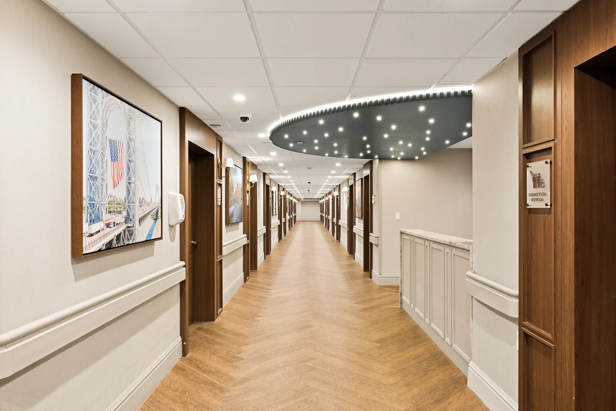An Amara corridor lined with framed artwork and wood doors