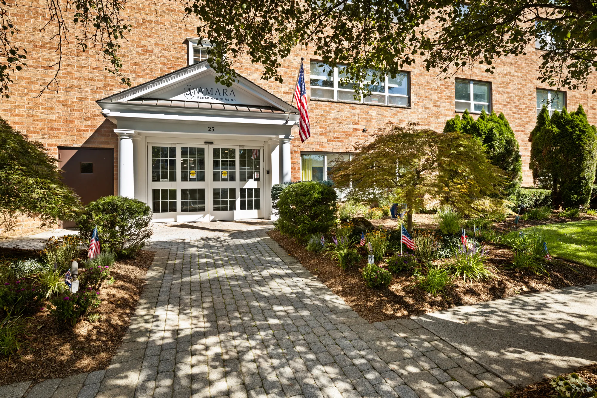 The Amara Rehab and Nursing entrance in Haskell, New Jersey, with the wordmark above the portico and the American flag beside it