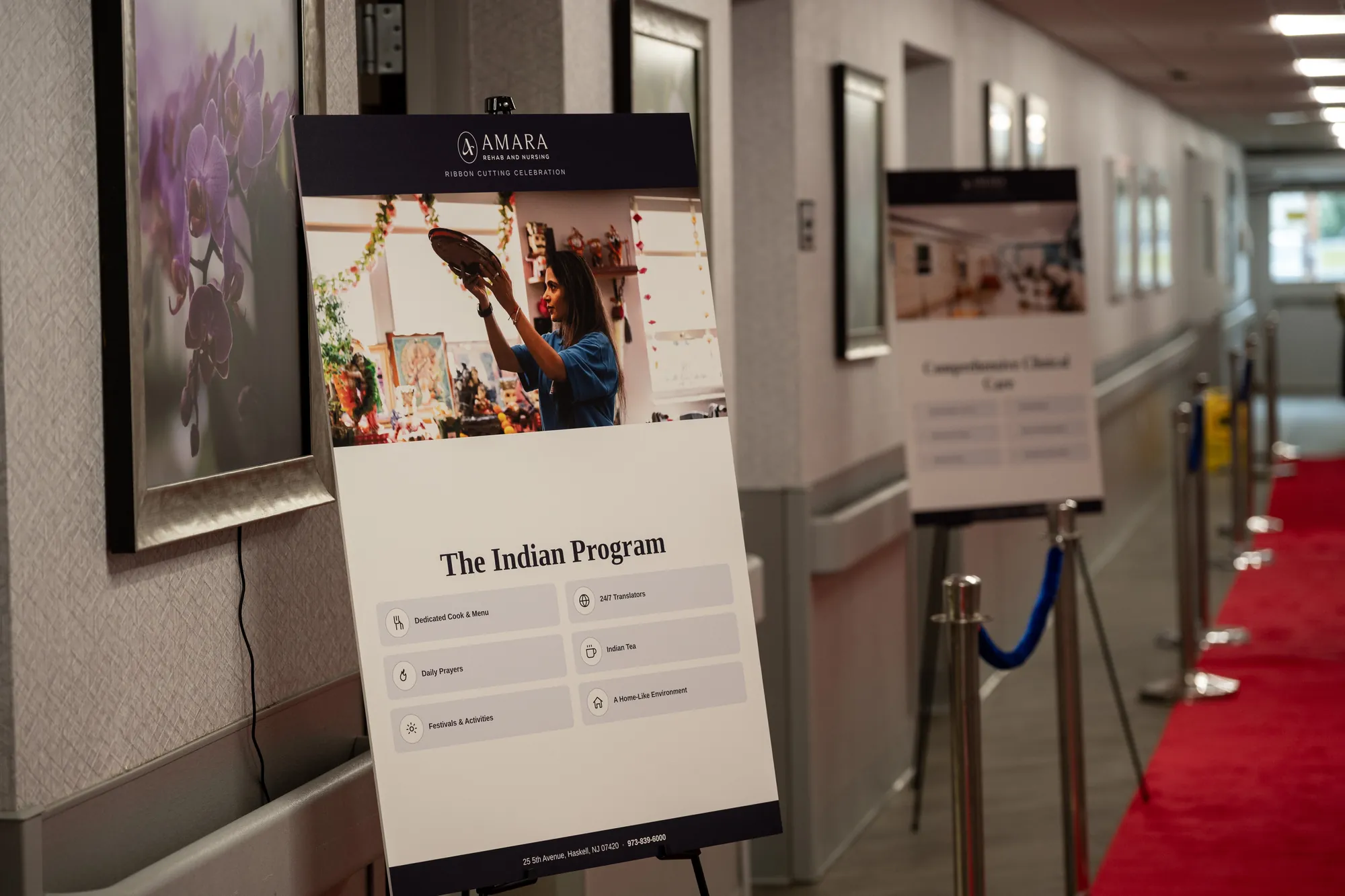 The red carpet running down the Amara corridor past framed prints on easels