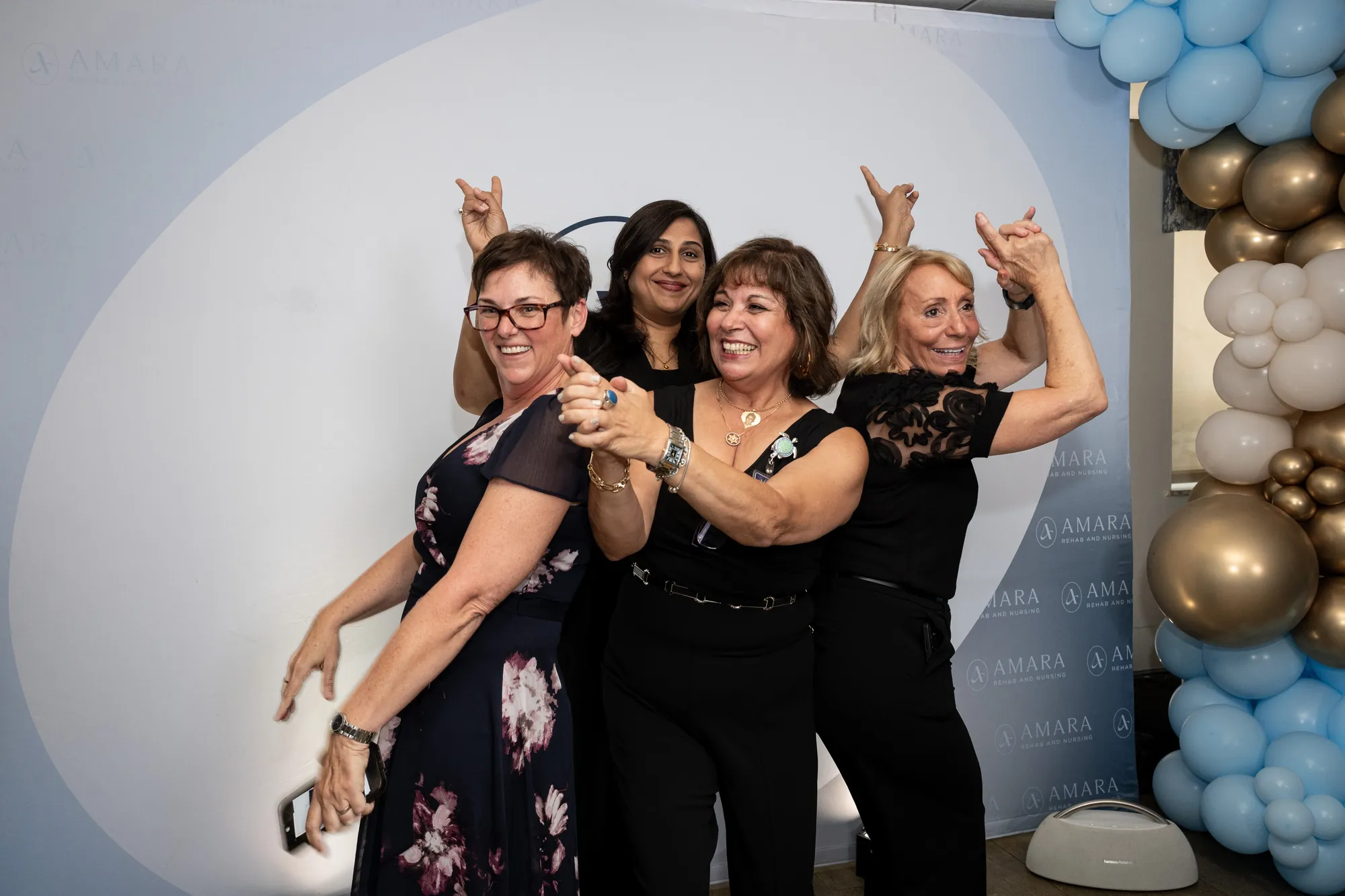 Amara staff celebrating together at the step and repeat