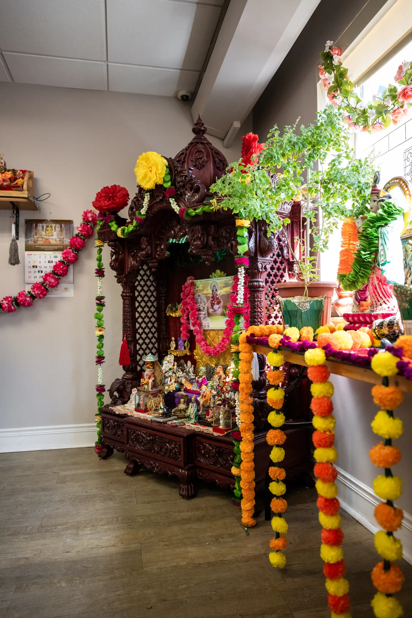 The shrine at Amara, hung with marigold garlands and set with devotional figures