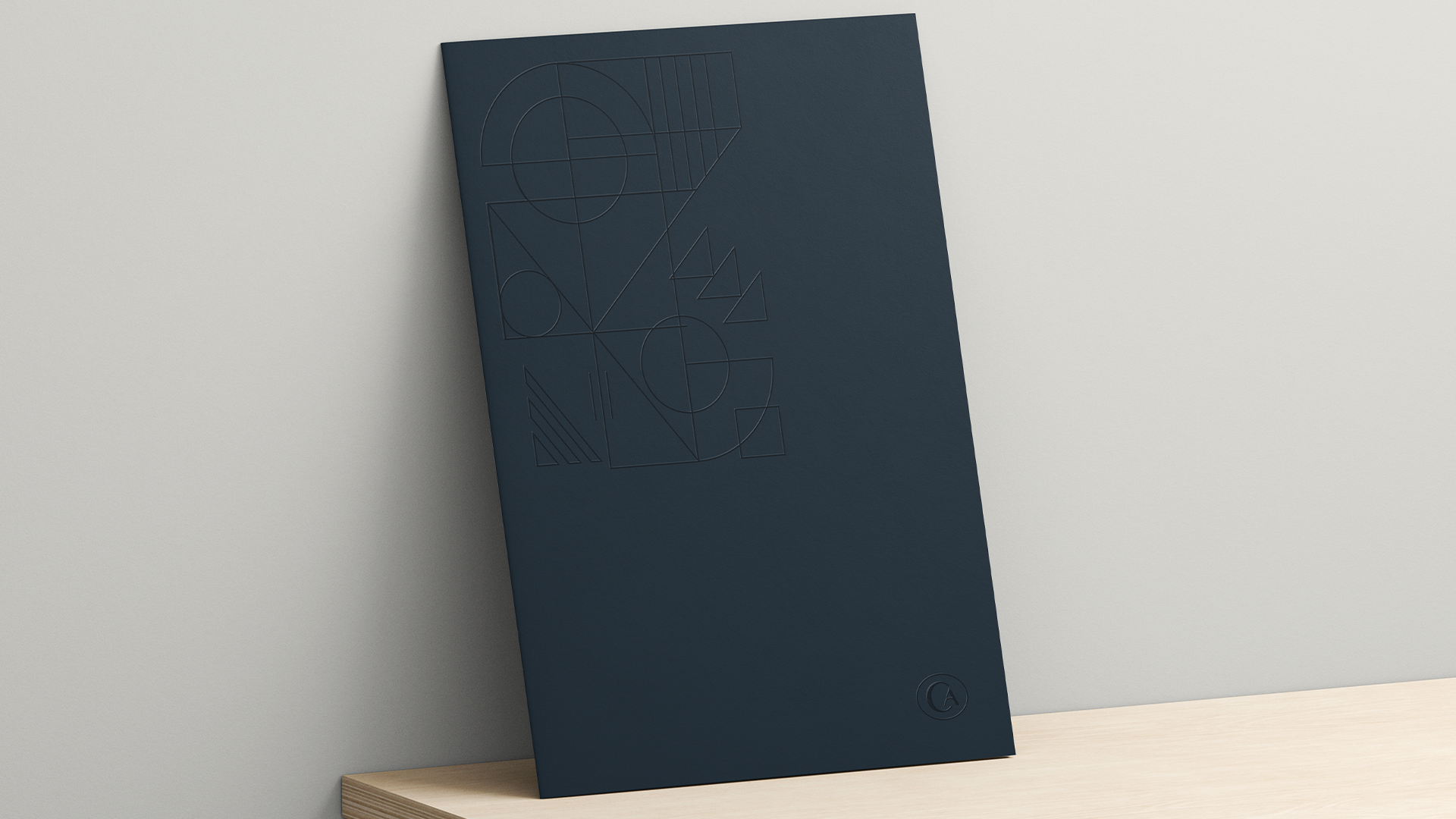 Navy Caliview Estates folder with a blind-embossed geometric pattern, propped on a light wood surface