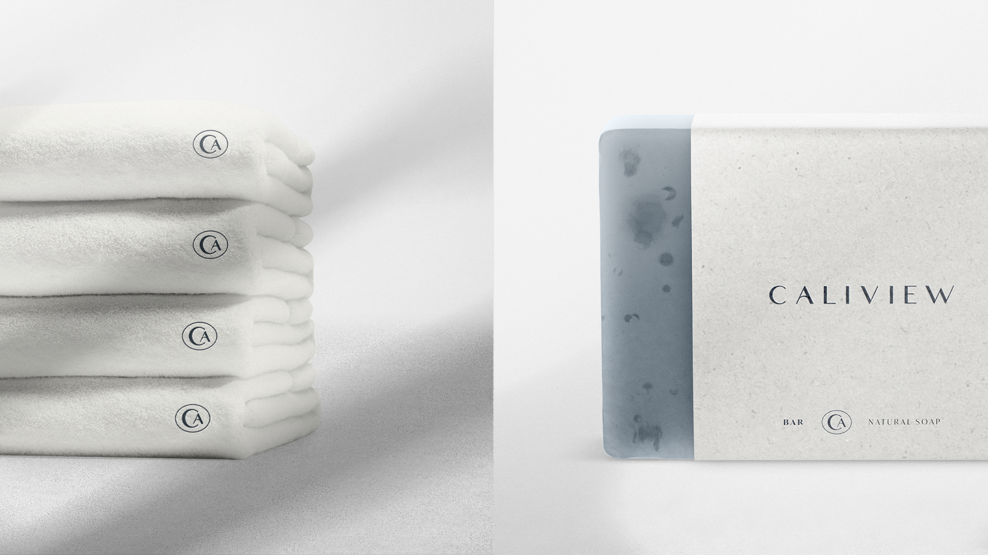 Stacked white towels embroidered with the Caliview CA monogram, beside a wrapped soap bar