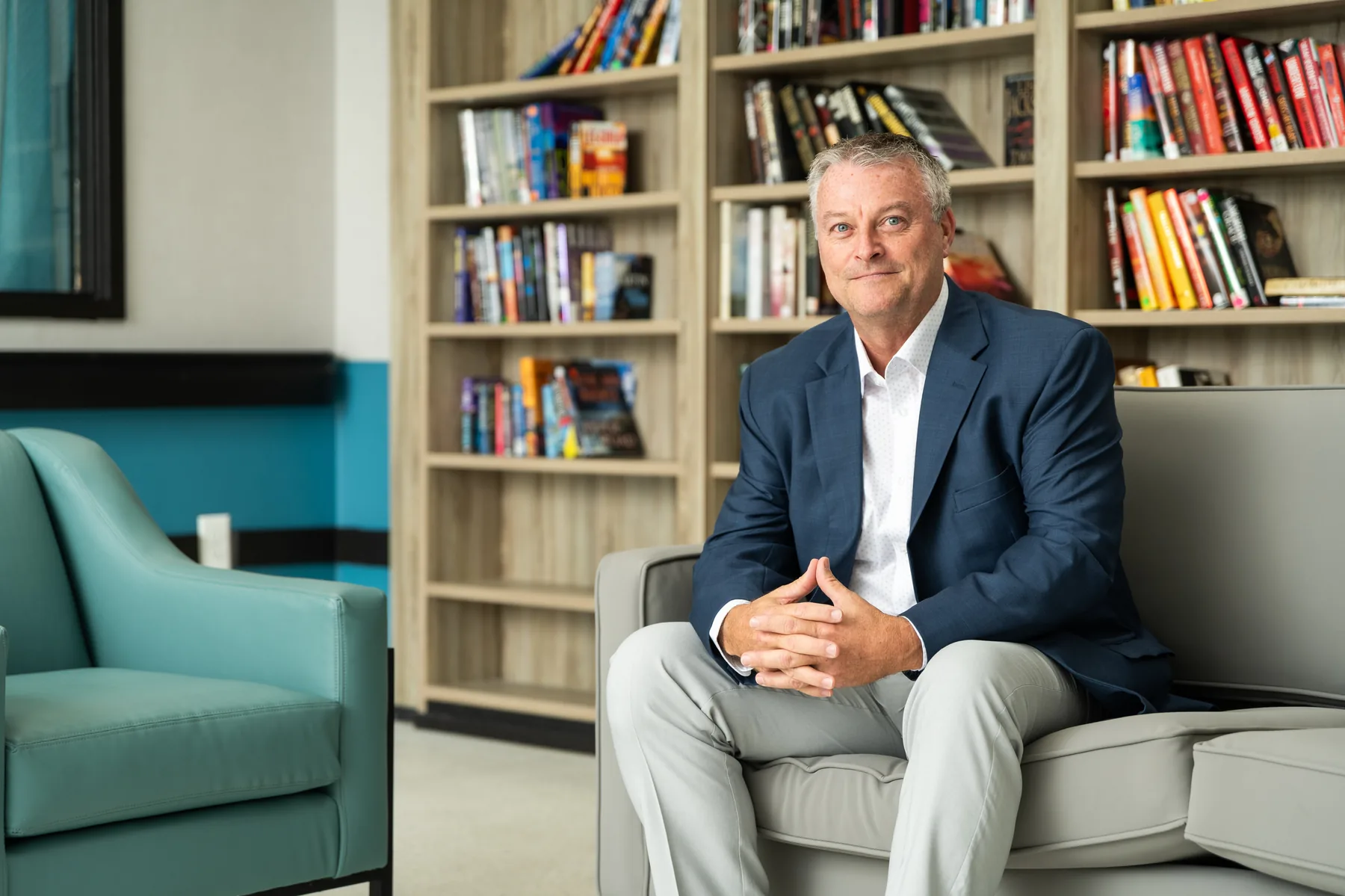 Carlton Shores leadership portrait, seated in the resident library