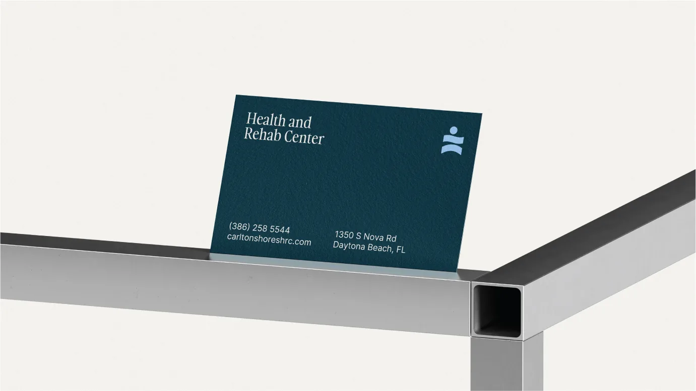 Carlton Shores business card on a metal stand