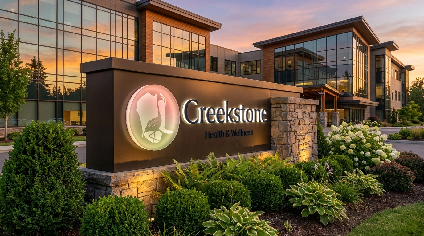 Creekstone Health & Wellness monument signage at dusk