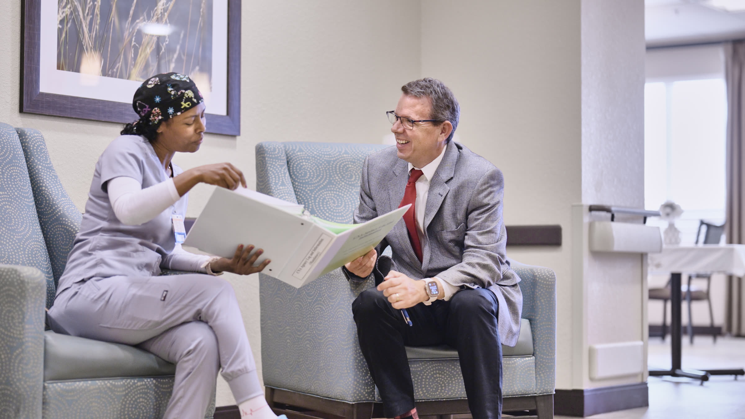 Therapist celebrating a resident's progress with a walker