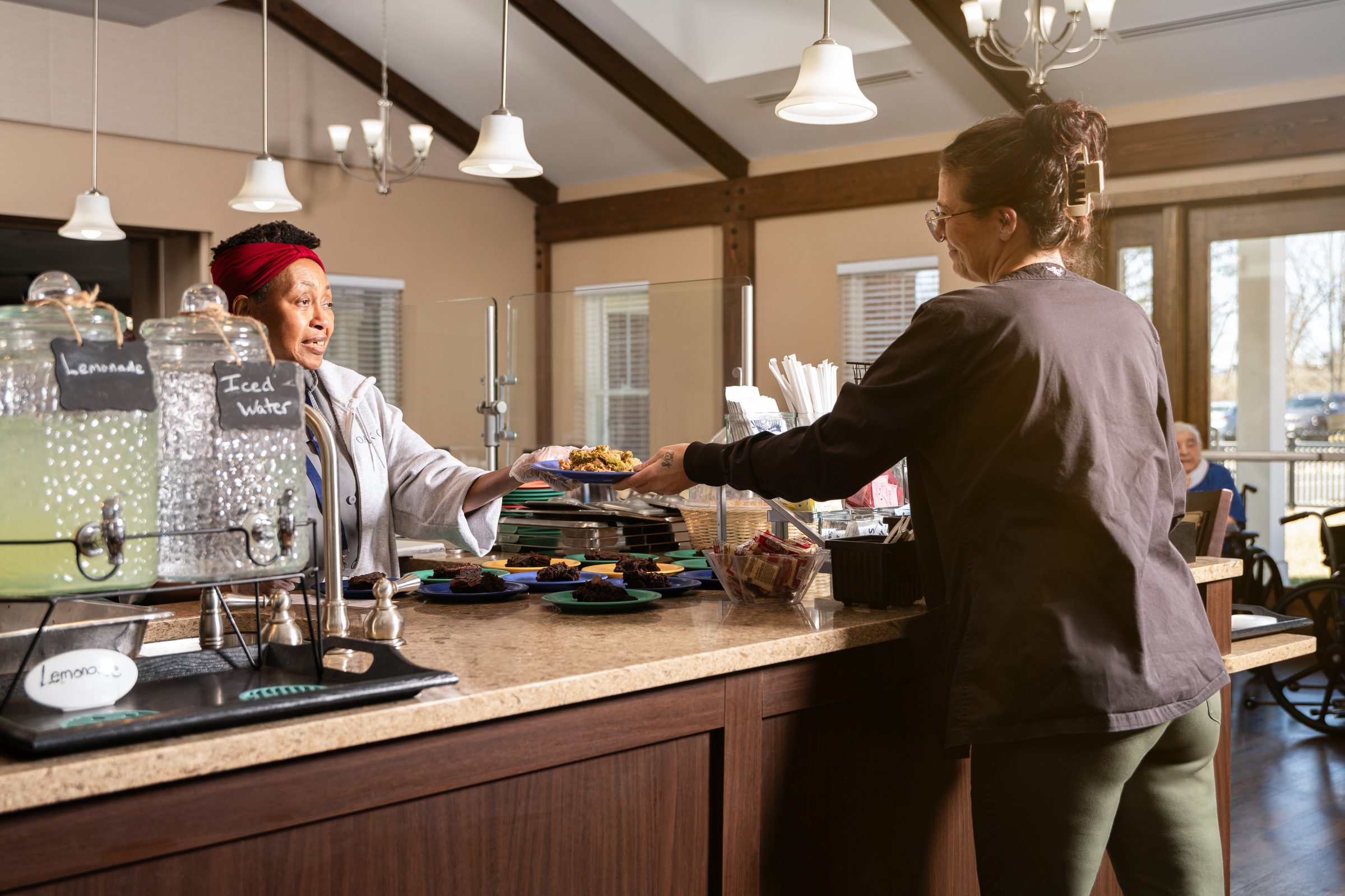 Oak Glen kitchen staff serving lunch at the buffet line