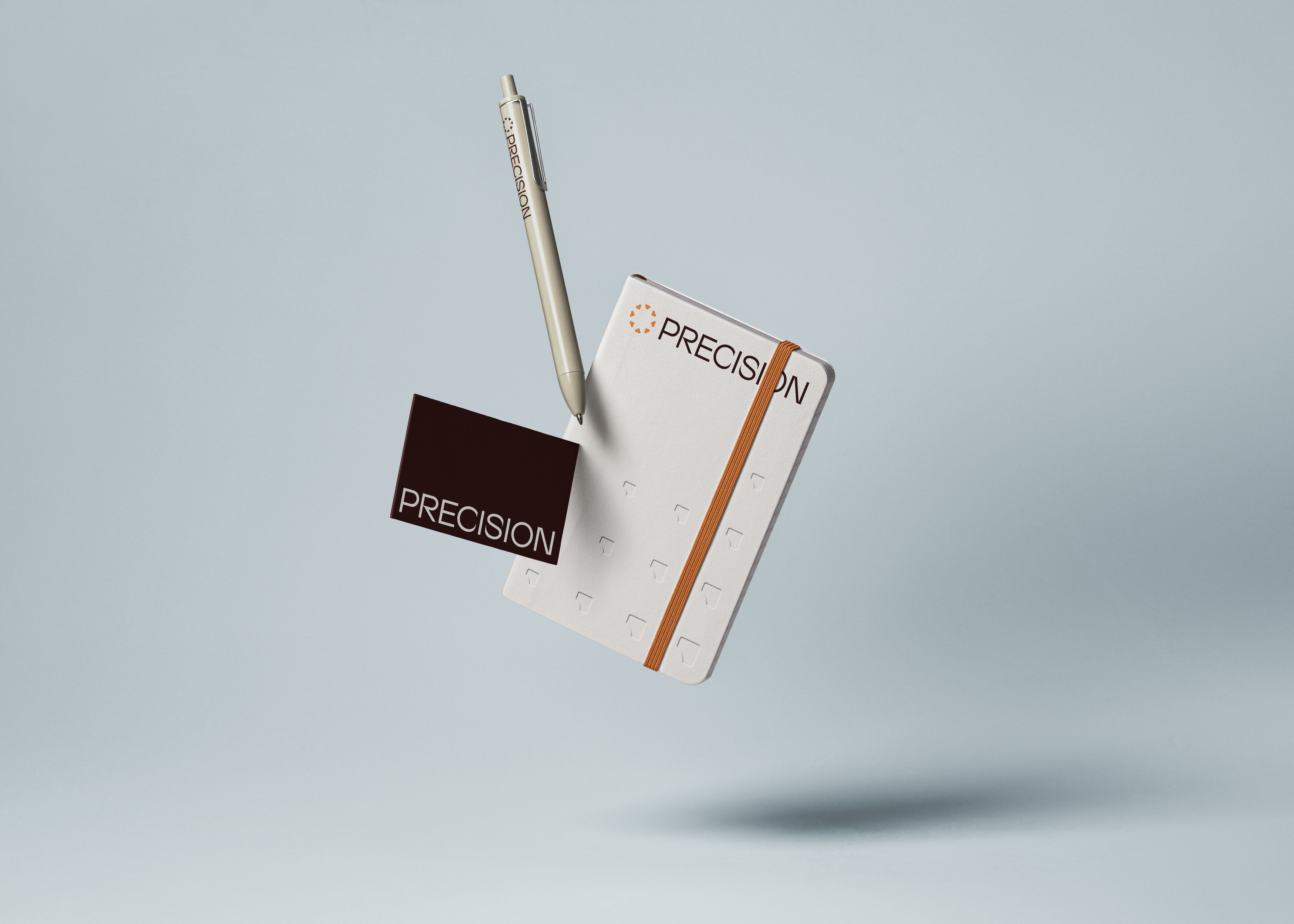 Precision notebook, pen, and card in mid-air against a pale blue background