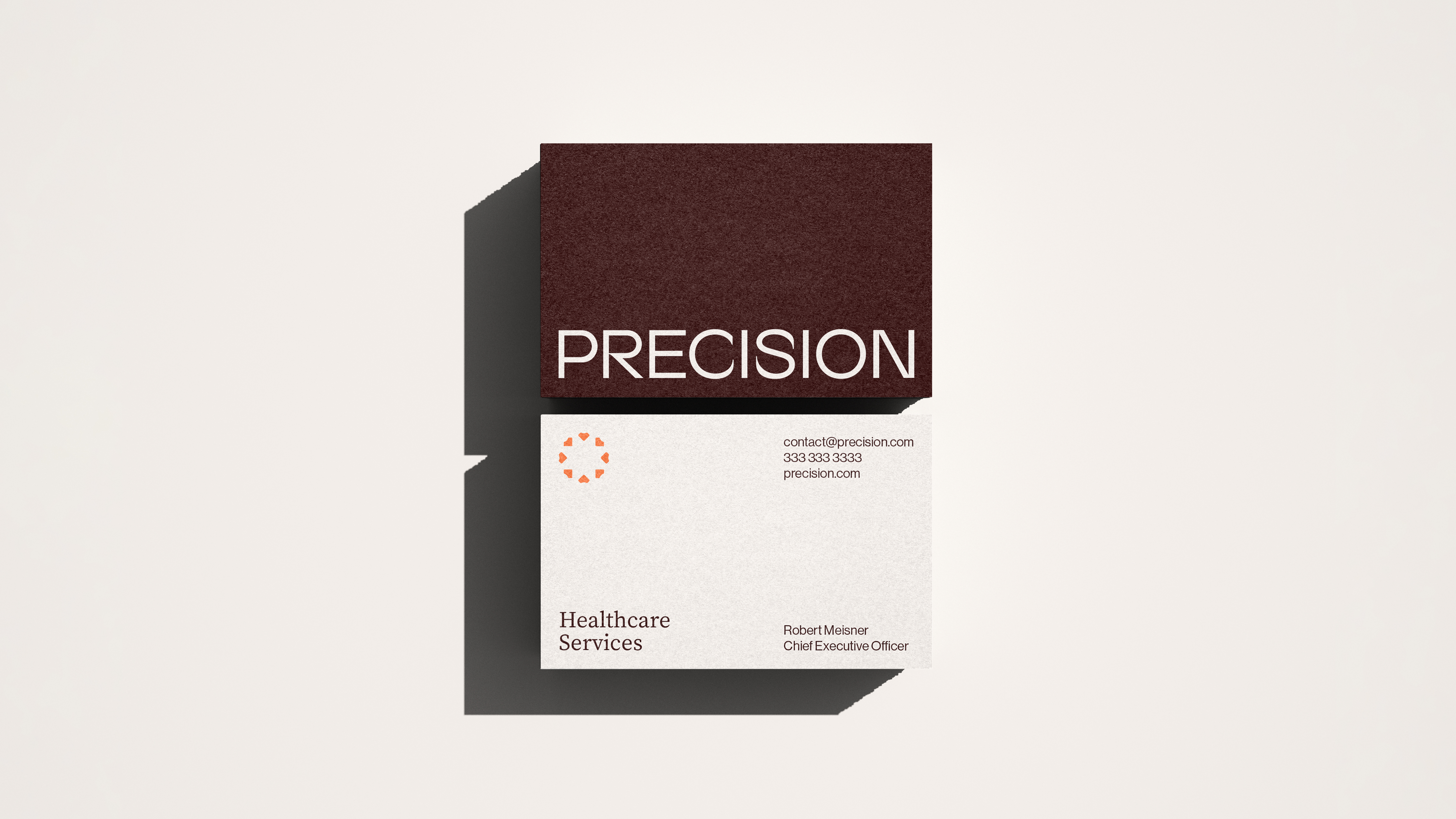 Precision business card, front and back, in oxblood and grey with the Healthcare Services line