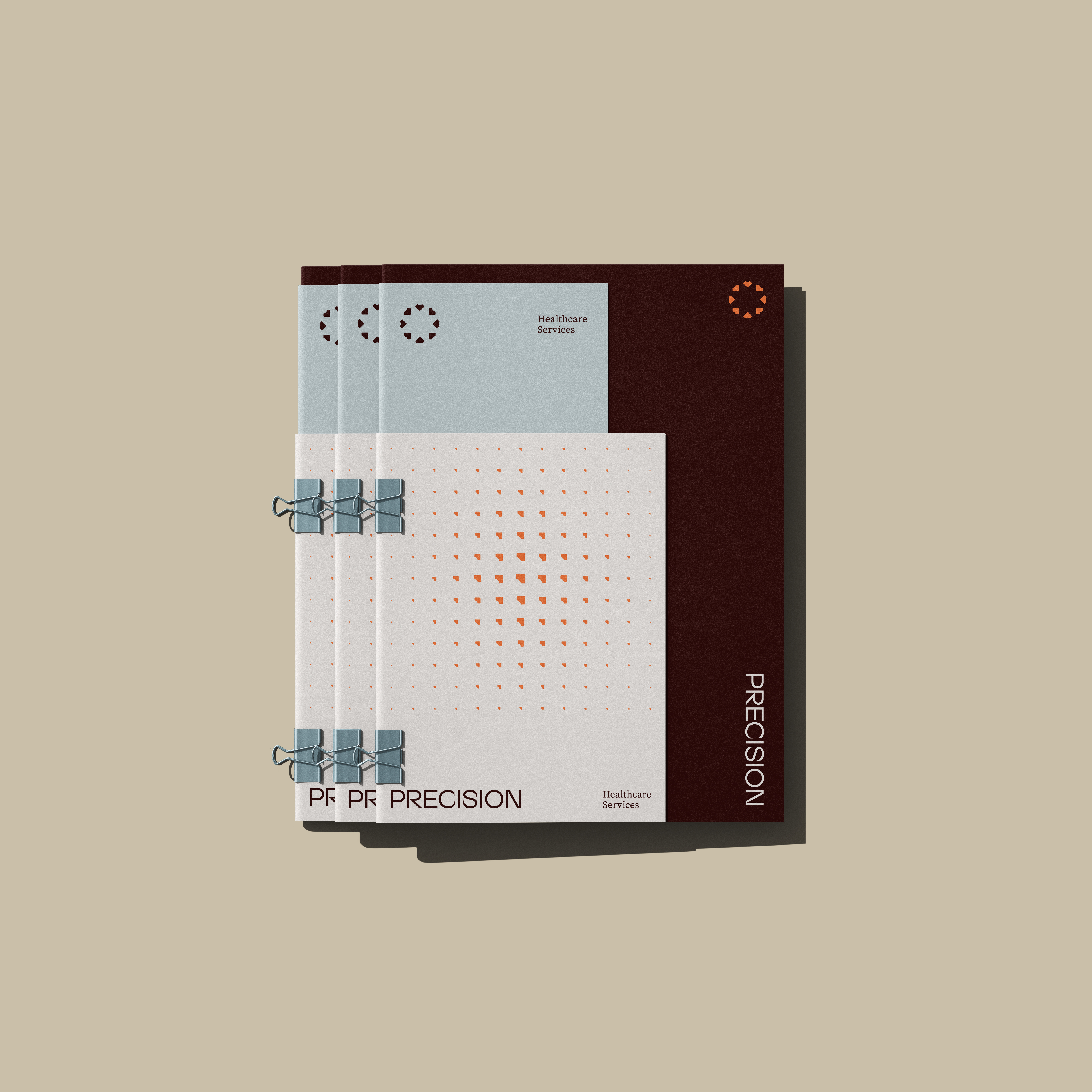 Three stacked Precision report booklets in pale blue and oxblood, bound with binder clips
