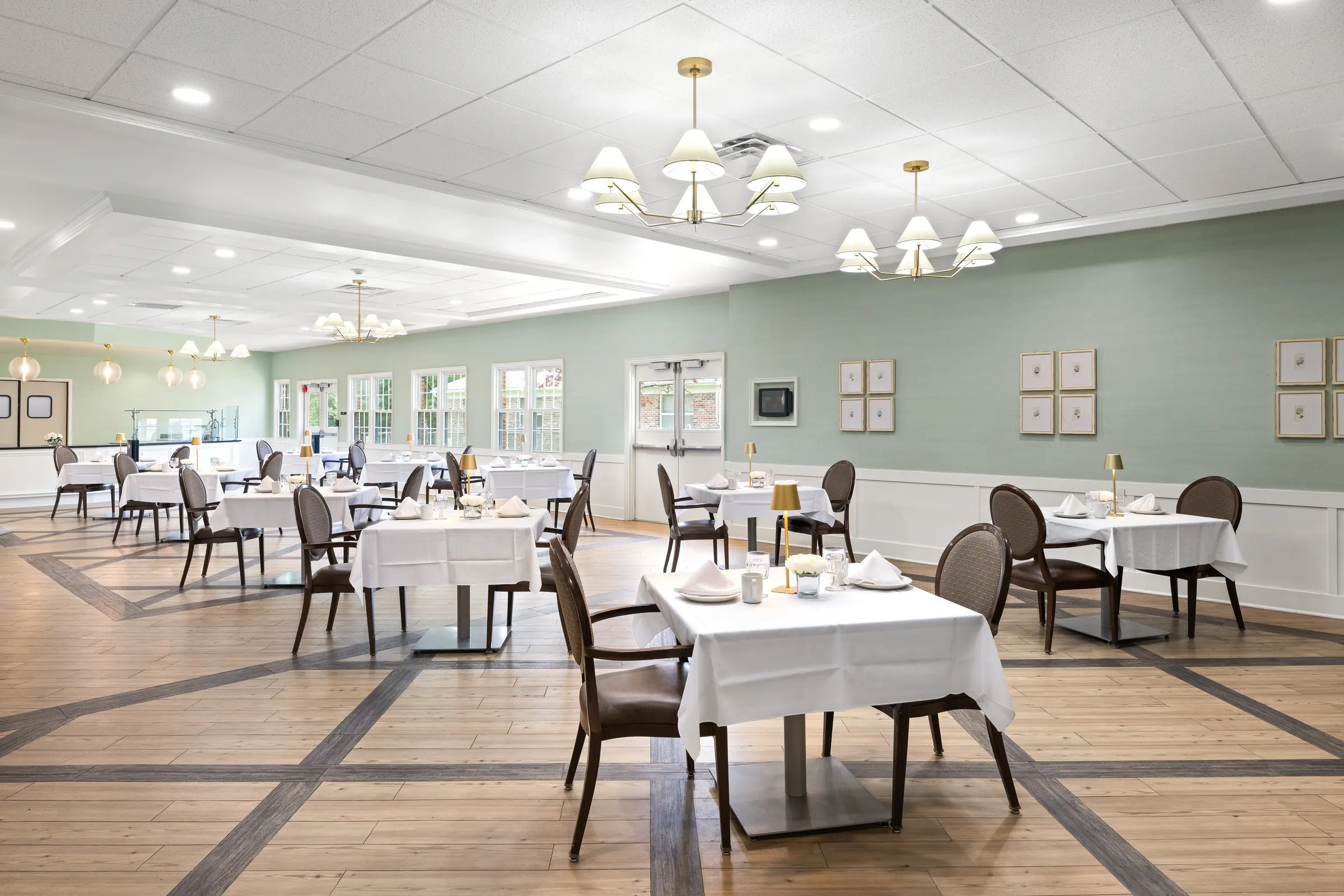 Dining room set with white linens and fresh flowers on every table