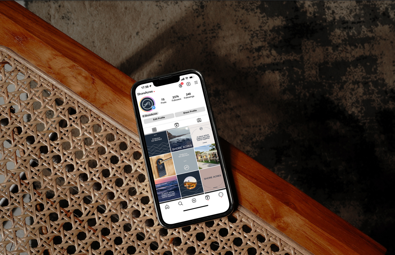 Phone on a cane and timber bench showing the Shore Acres Instagram profile grid