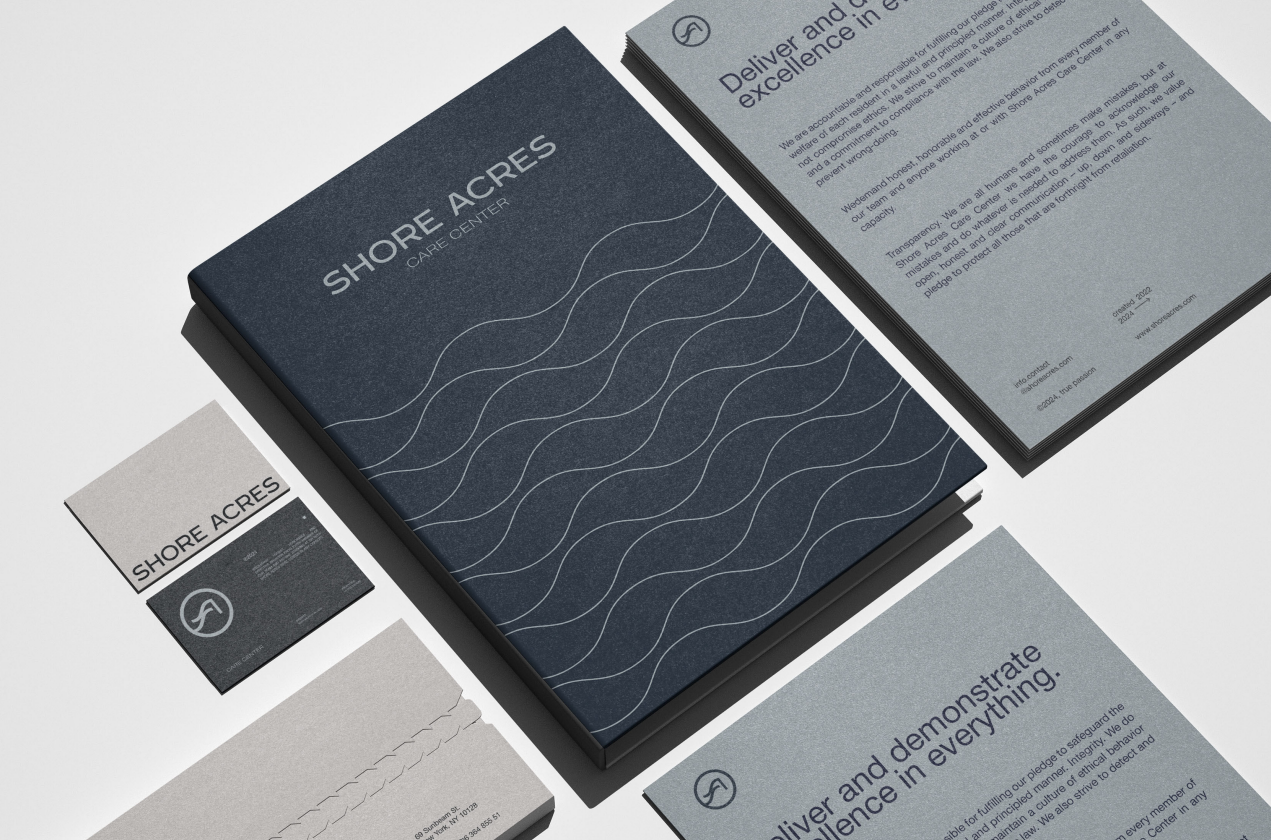 Shore Acres stationery suite with the navy wave-pattern book, business cards, and printed values sheets
