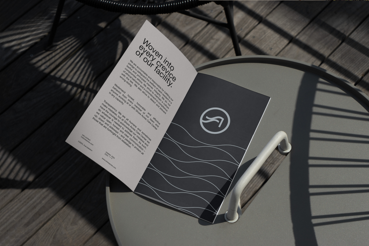 Open Shore Acres brochure on an outdoor table reading Woven into every crevice of our facility