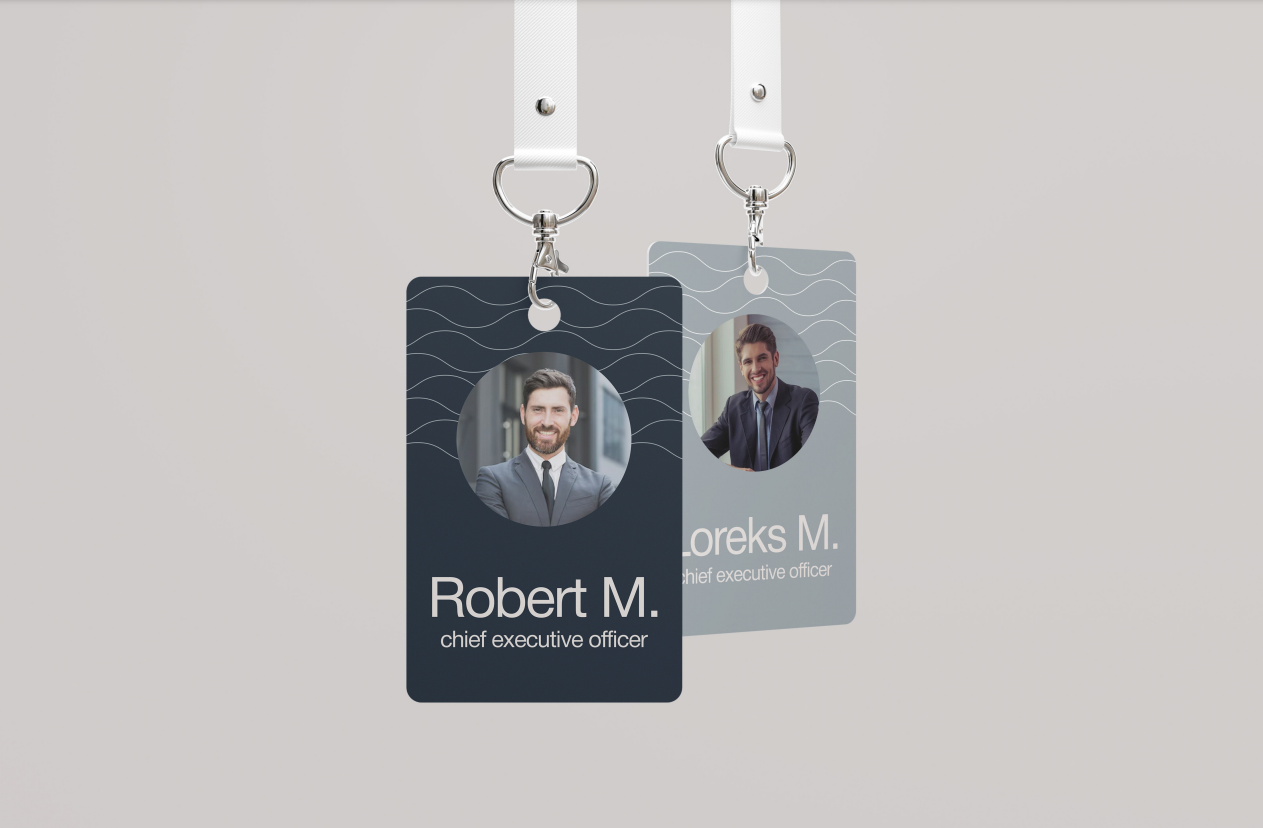 Two Shore Acres staff ID badges on lanyards, showing the wave pattern and a photo panel
