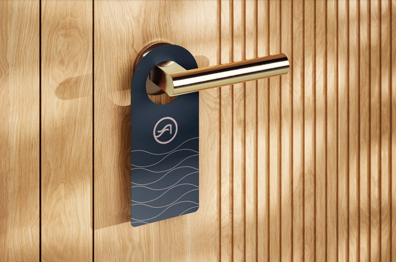 Navy Shore Acres Care Center door hanger with the wave monogram, on a brass handle against wood panelling