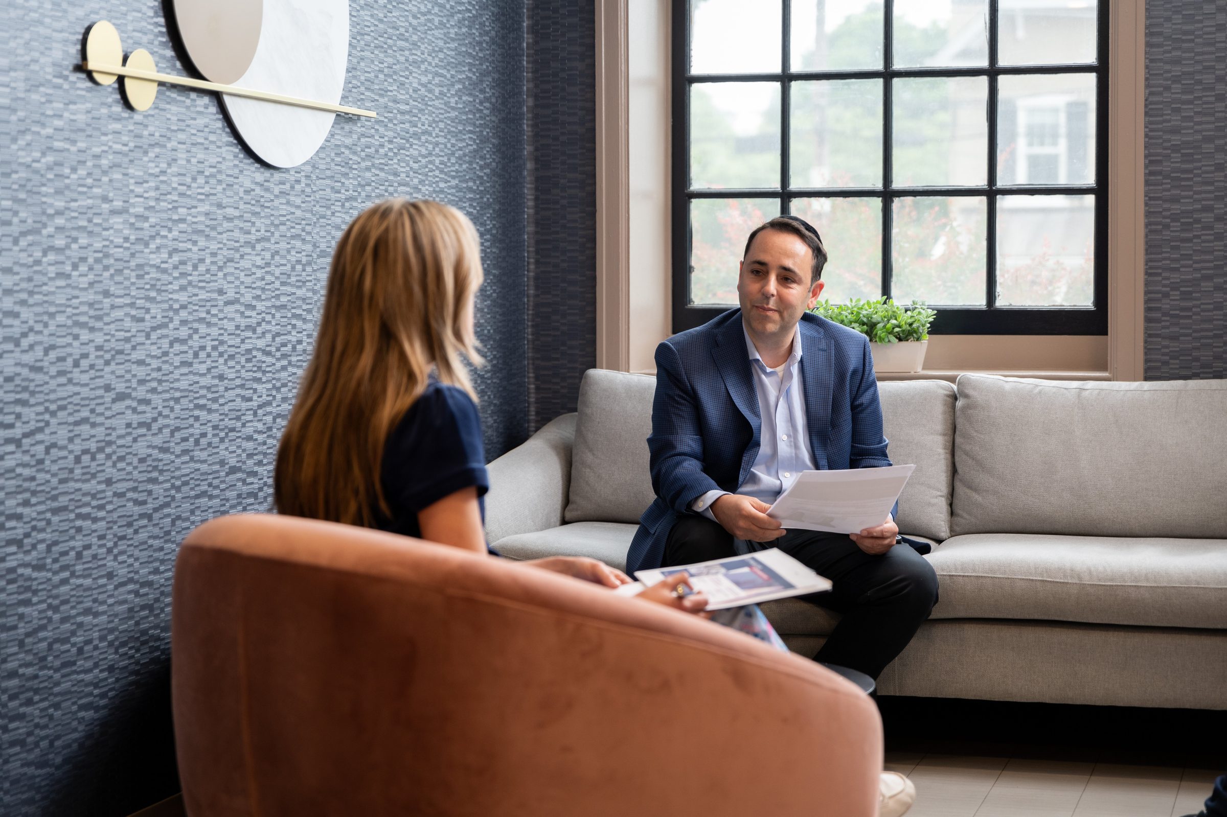 SilverKey staff reviewing materials with a clinician on the lounge