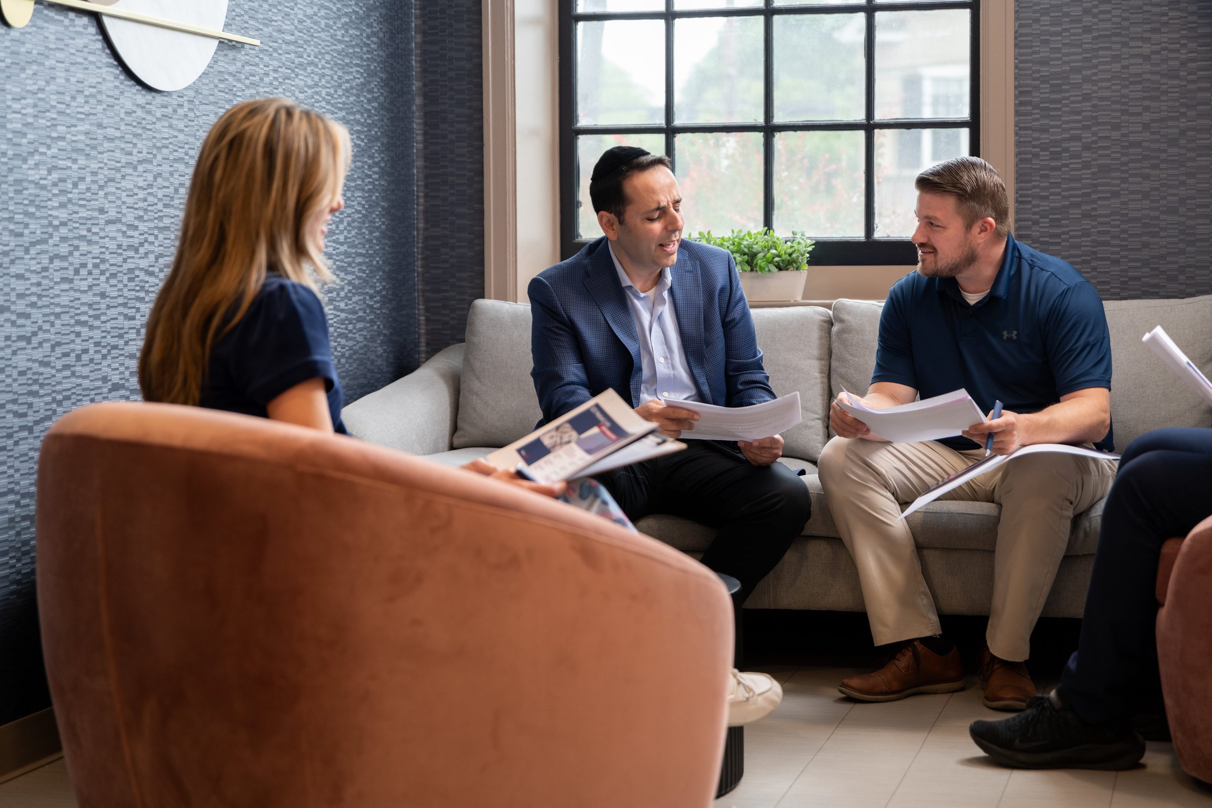Three SilverKey team members reviewing print collateral together