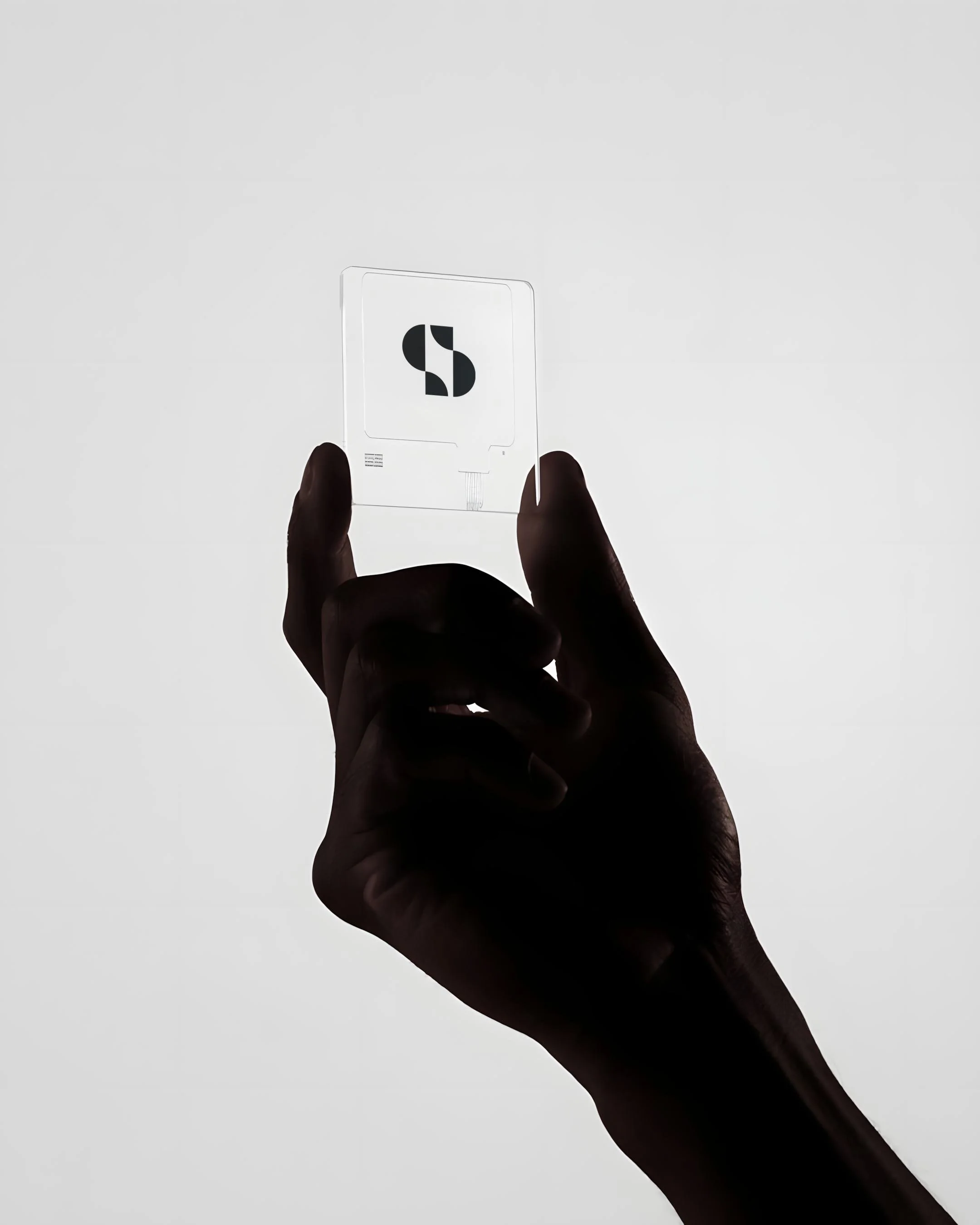 Symbiosis Advisors transparent ID card with S monogram