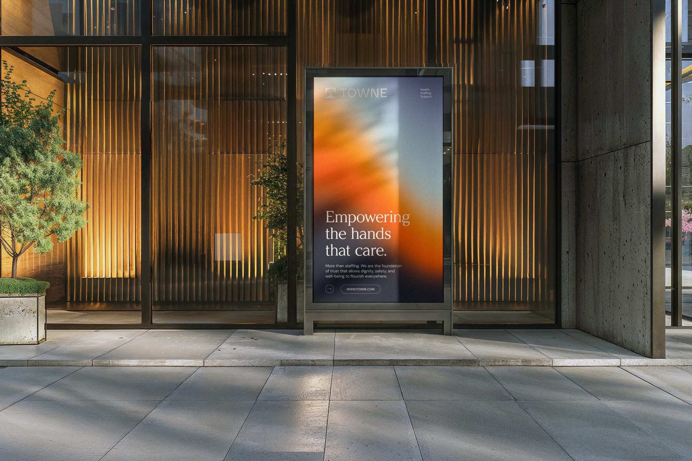 Illuminated Towne Group sidewalk poster reading Empowering the hands that care