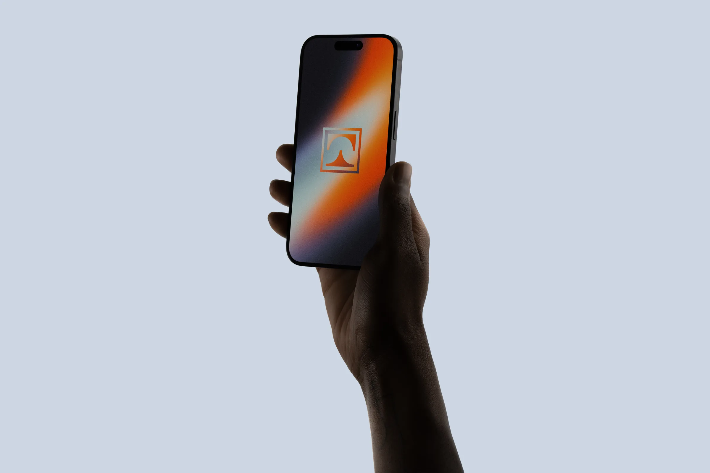 Hand holding a phone showing the Towne Group logo mark on an orange and blue gradient lock screen