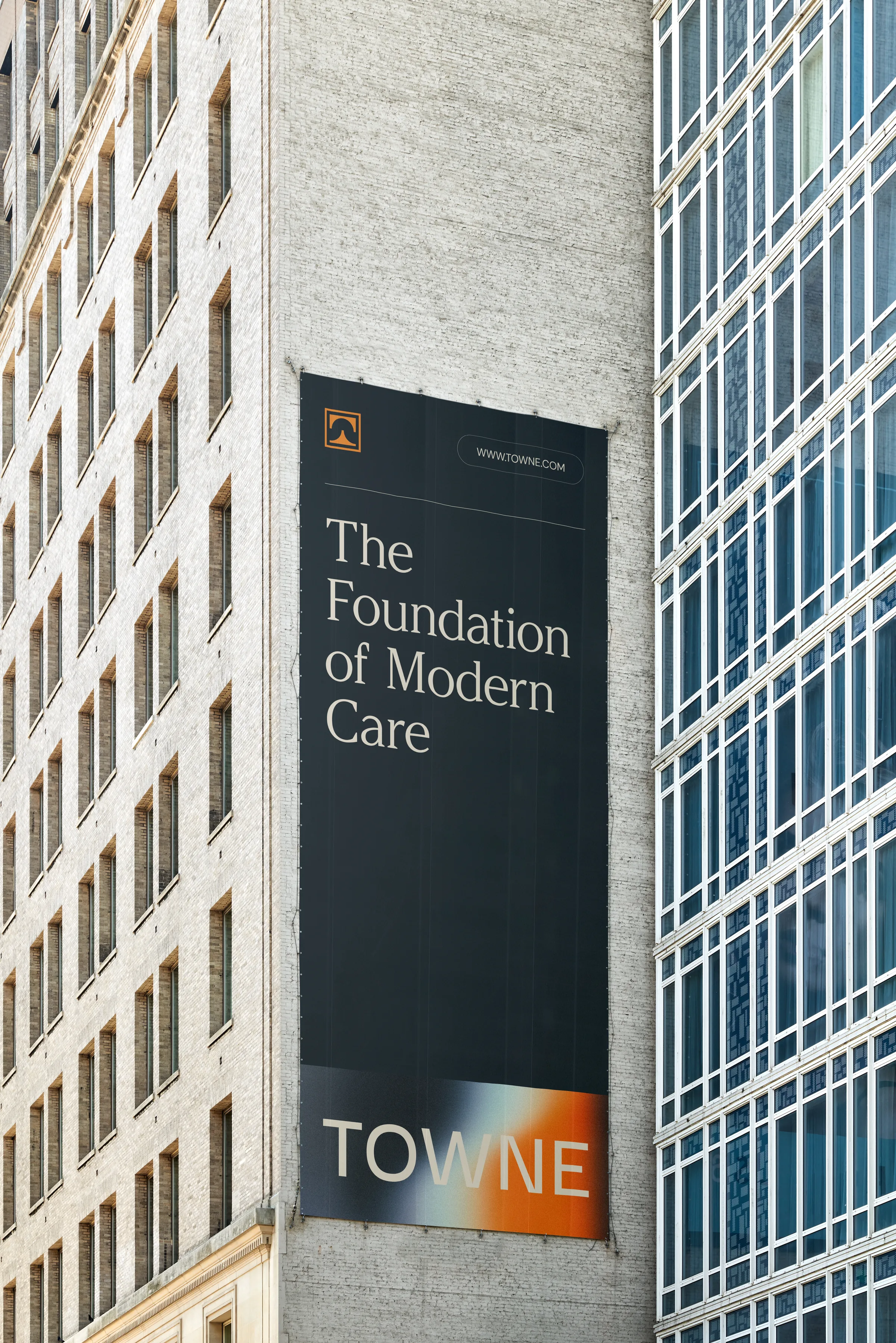 Building-scale Towne Group banner reading The Foundation of Modern Care above the gradient wordmark