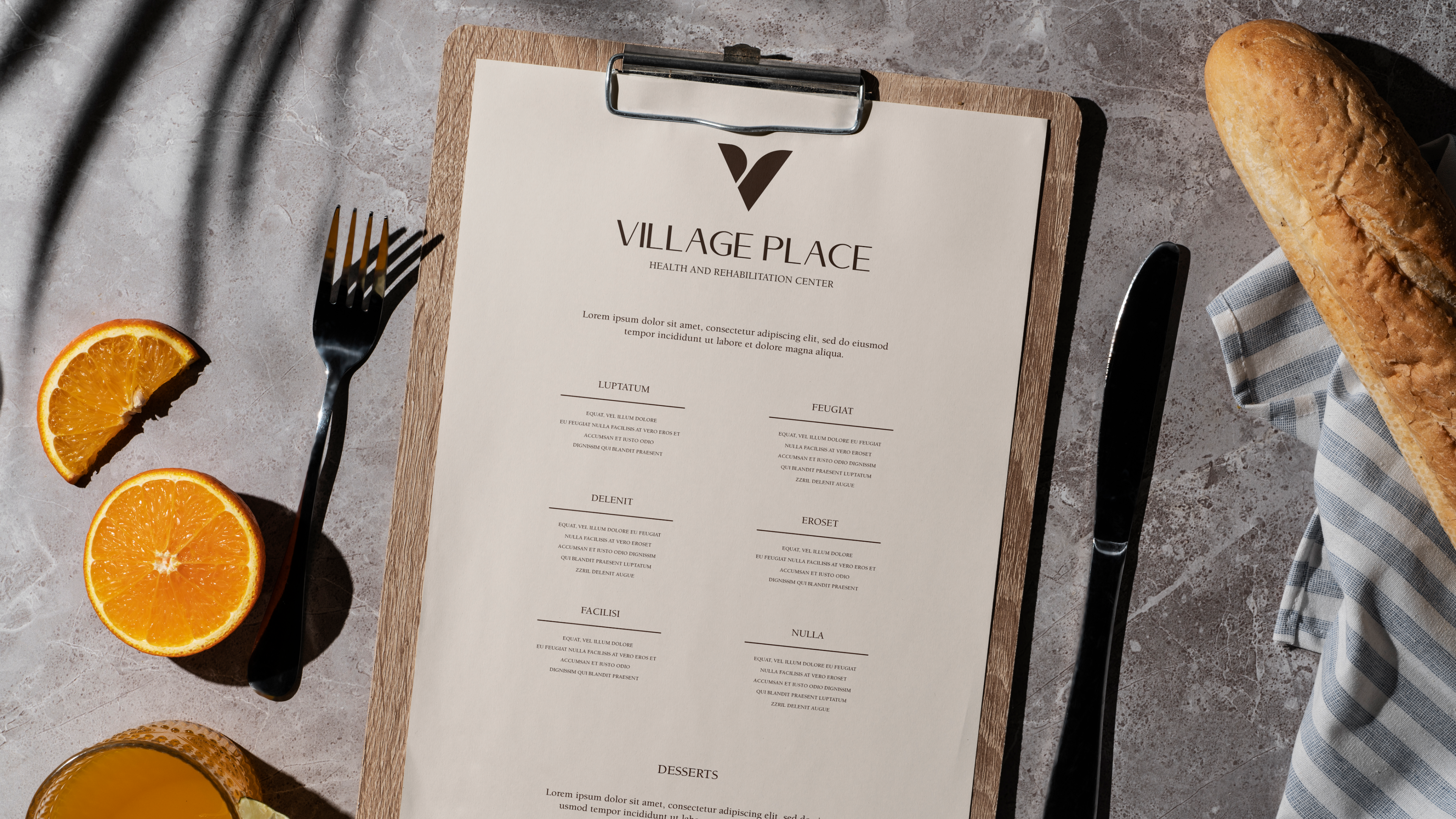 Village Place dining menu on marble surface with food and orange juice styling
