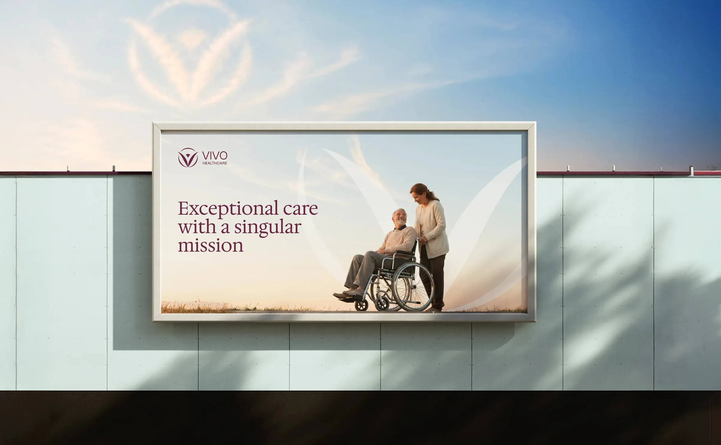 A Vivo Healthcare billboard reading Exceptional care with a singular mission, with a caregiver and a resident in a wheelchair