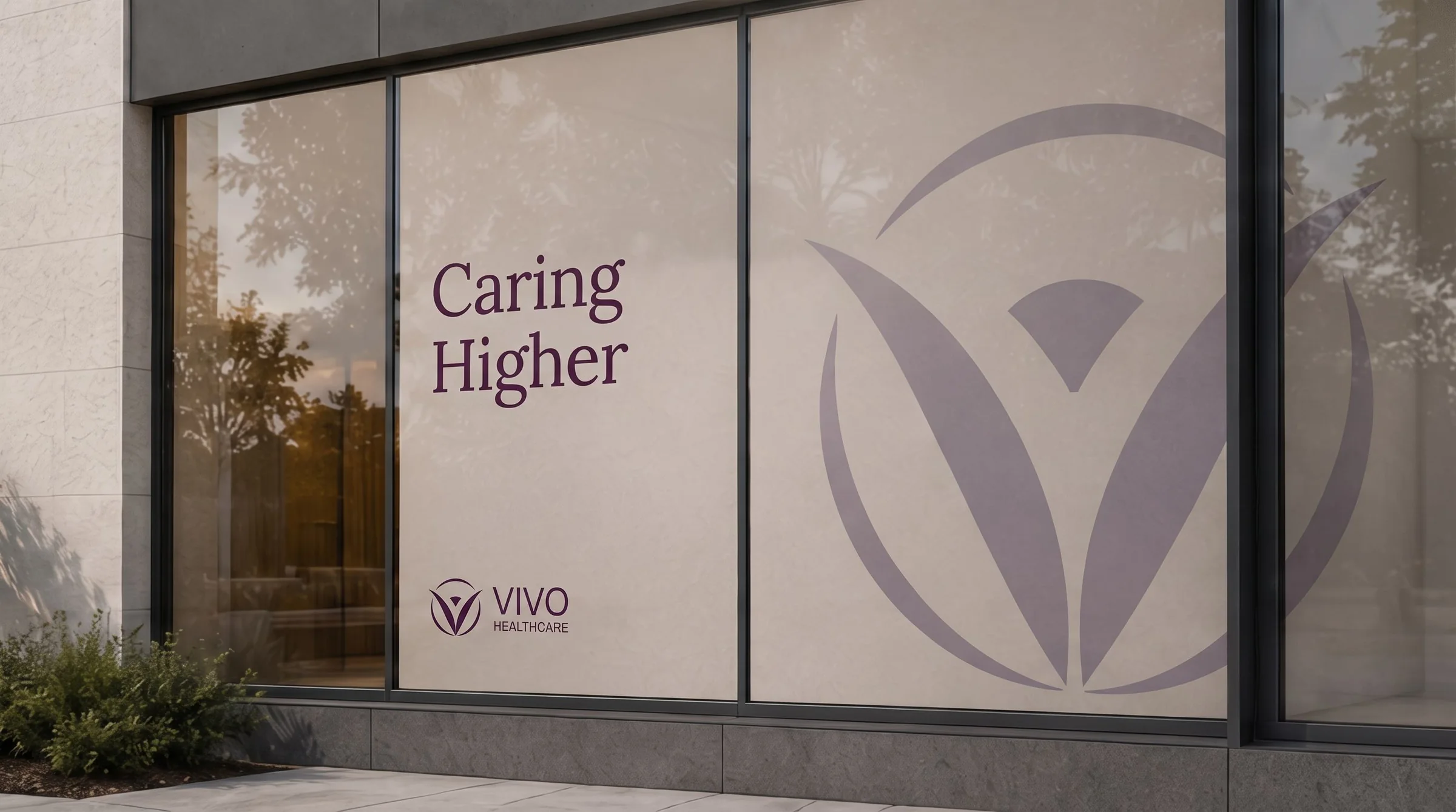 Caring Higher and the Vivo Healthcare logo applied to a glass storefront, with the mark frosted large across the window